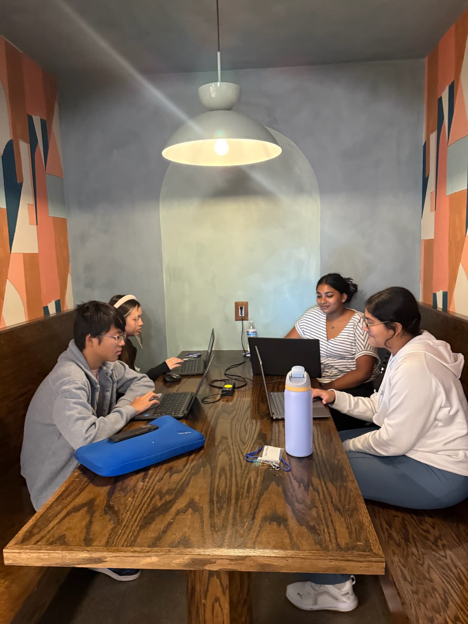 High school students coding during the overnight hacking session at Hack the Track 2025