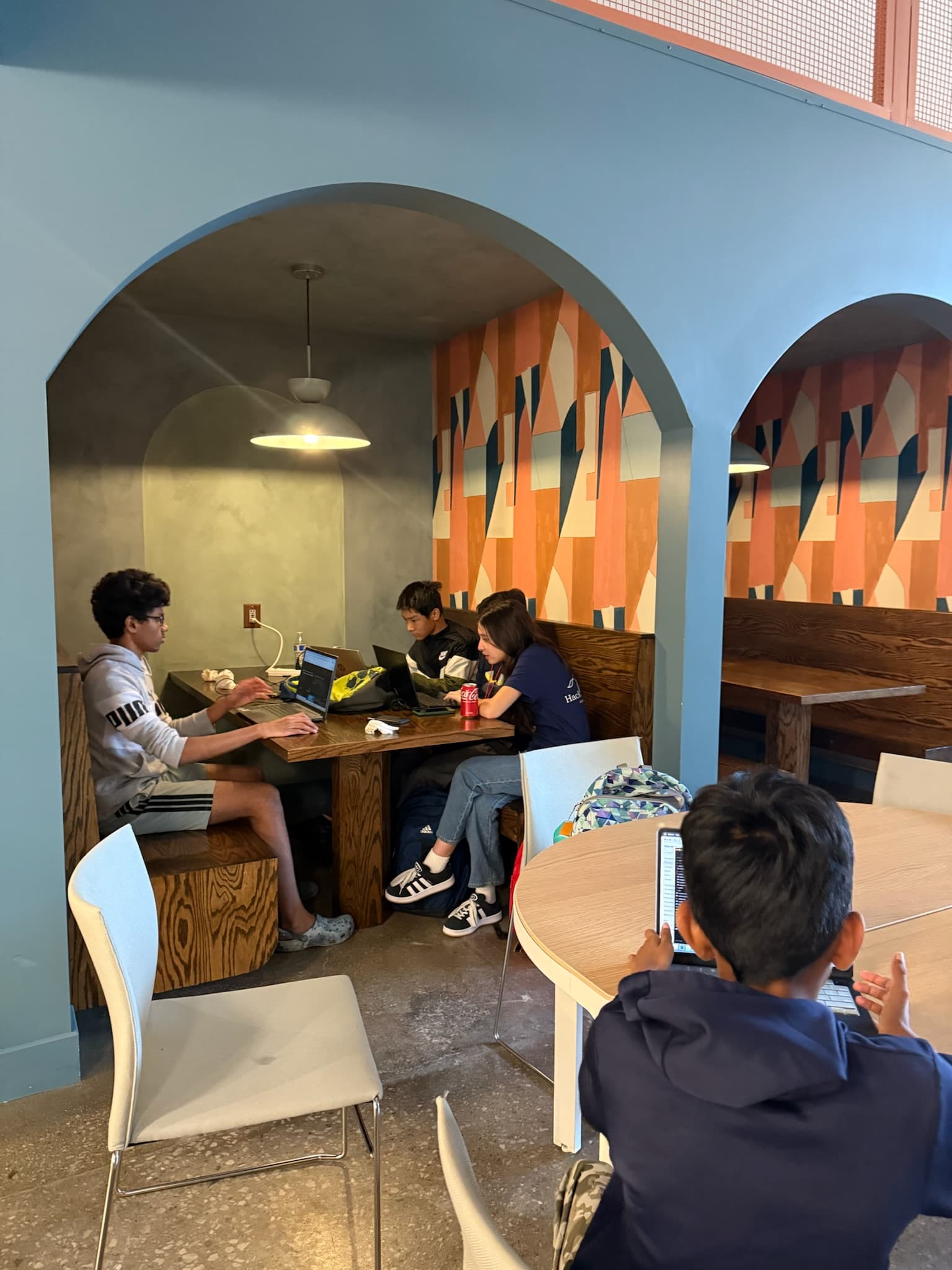 Student developers building their project during the Hack the Track 2025 hackathon