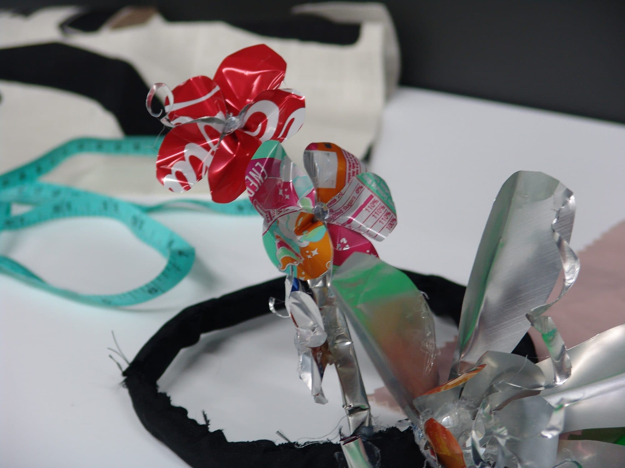 A flower sculpted from cut-up aluminum cans, made during the KMAC sustainable fashion Learnathon