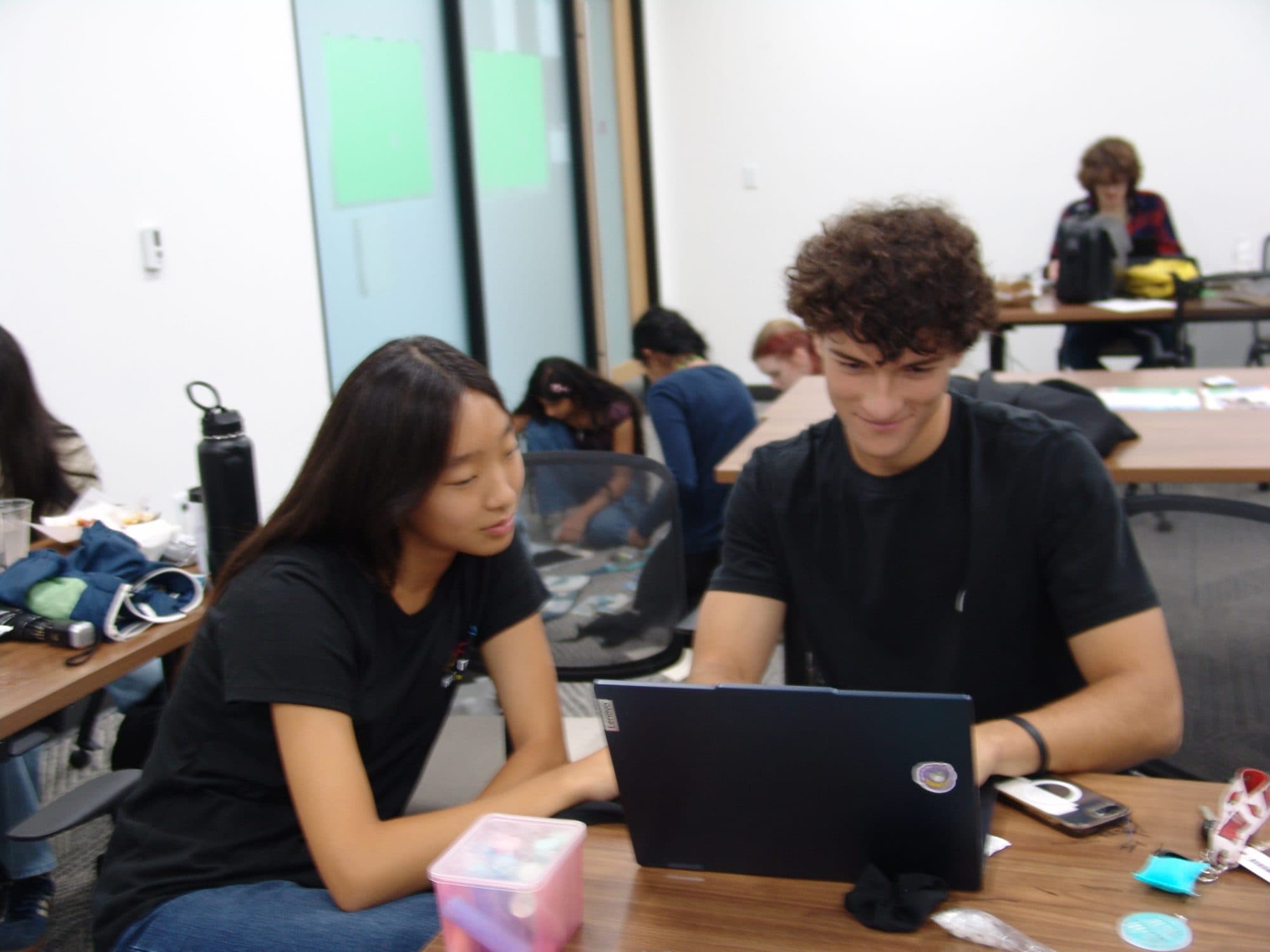 Two students pair-programming on a laptop during the software track at Hack the Track 2026