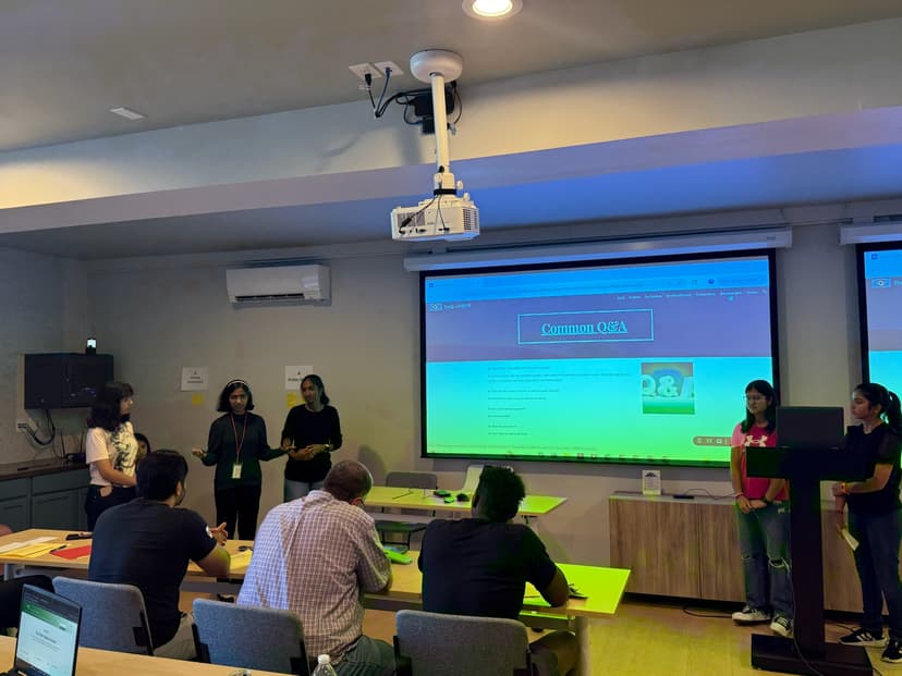 Student team presenting their hackathon project to judges at Hack the Track 2025